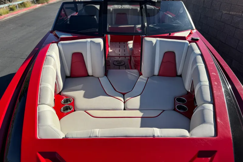 Slide: The Image of 2018 Malibu Wakesetter 21 MLX boat interior with red and white seating. - 13