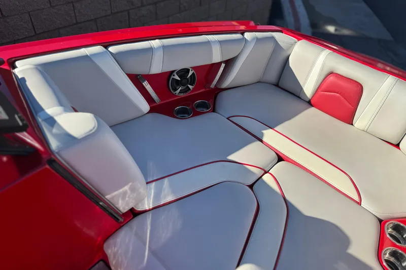 Slide: The Image of 2018 Malibu Wakesetter 21 MLX boat interior with red and white seating. - 15