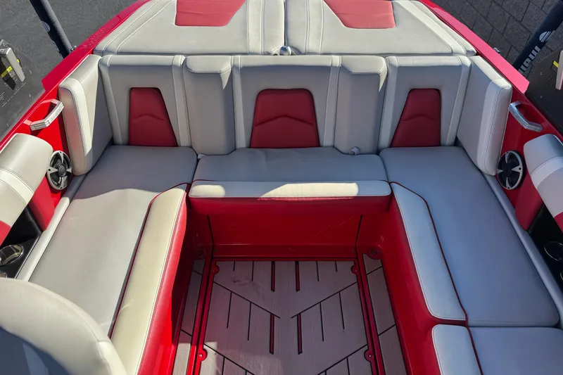 Slide: The Image of 2018 Malibu Wakesetter 21 MLX interior with red and gray seating. - 19