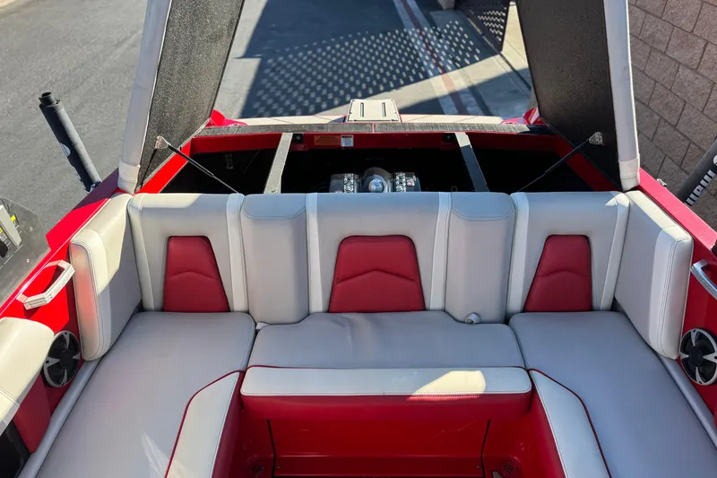 Slide: The Image of 2018 Malibu Wakesetter 21 MLX boat interior with red and white seating. - 20