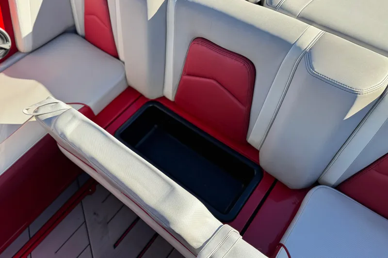 Slide: The Image of 2018 Malibu Wakesetter 21 MLX interior seating with storage compartment. - 23