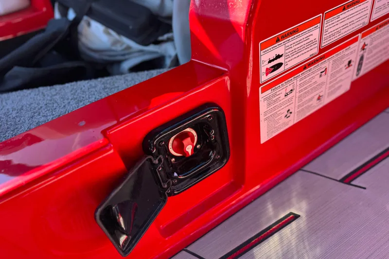 Slide: The Image of Red 2018 Malibu Wakesetter 21 MLX boat interior with safety warnings and latch. - 27