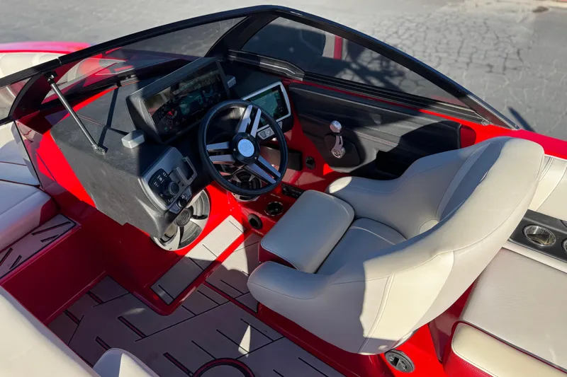Slide: The Image of 2018 Malibu Wakesetter 21 MLX boat interior with red accents and modern dashboard. - 28