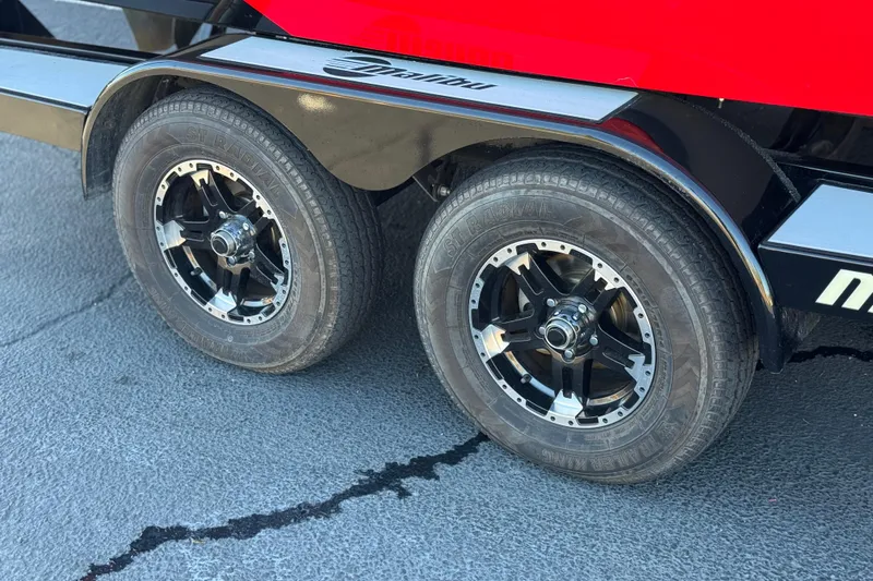 Slide: The Image of 2018 Malibu Wakesetter 21 MLX trailer wheels on pavement. - 40