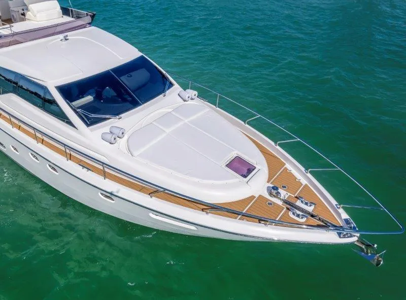 Slide: The Image of 2011 Ferretti Yachts 660 cruising on clear green water. - 11