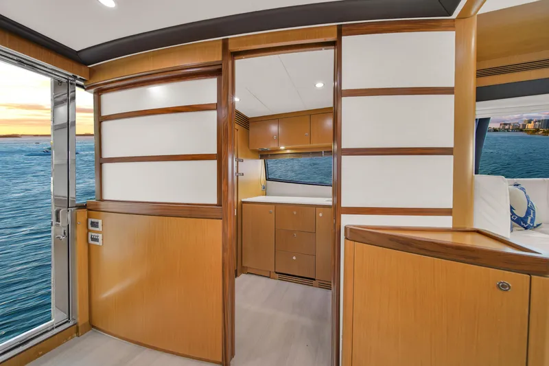 Slide: The Image of Luxurious interior of 2011 Ferretti Yachts 660 with wood paneling and ocean view. - 26