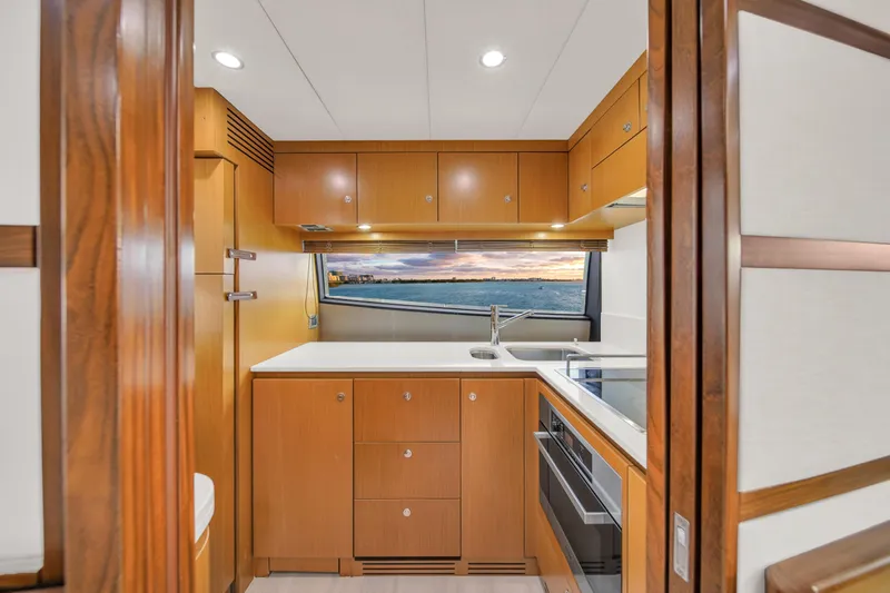 Slide: The Image of Luxurious kitchen interior of 2011 Ferretti Yachts 660 with modern wood cabinetry and ocean view. - 27