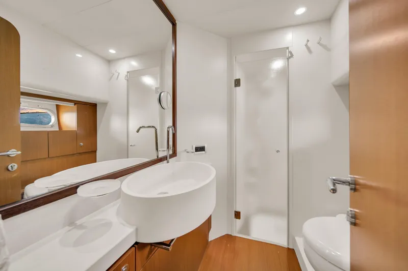 Slide: The Image of Luxurious bathroom interior of 2011 Ferretti Yachts 660 with modern fixtures and wood accents. - 39