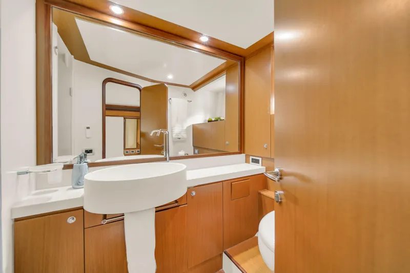 Slide: The Image of Luxurious bathroom interior of 2011 Ferretti Yachts 660 with modern fixtures and wood accents. - 43
