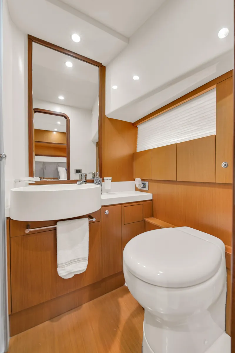 Slide: The Image of Luxurious bathroom in 2011 Ferretti Yachts 660 with modern fixtures and wood accents. - 44