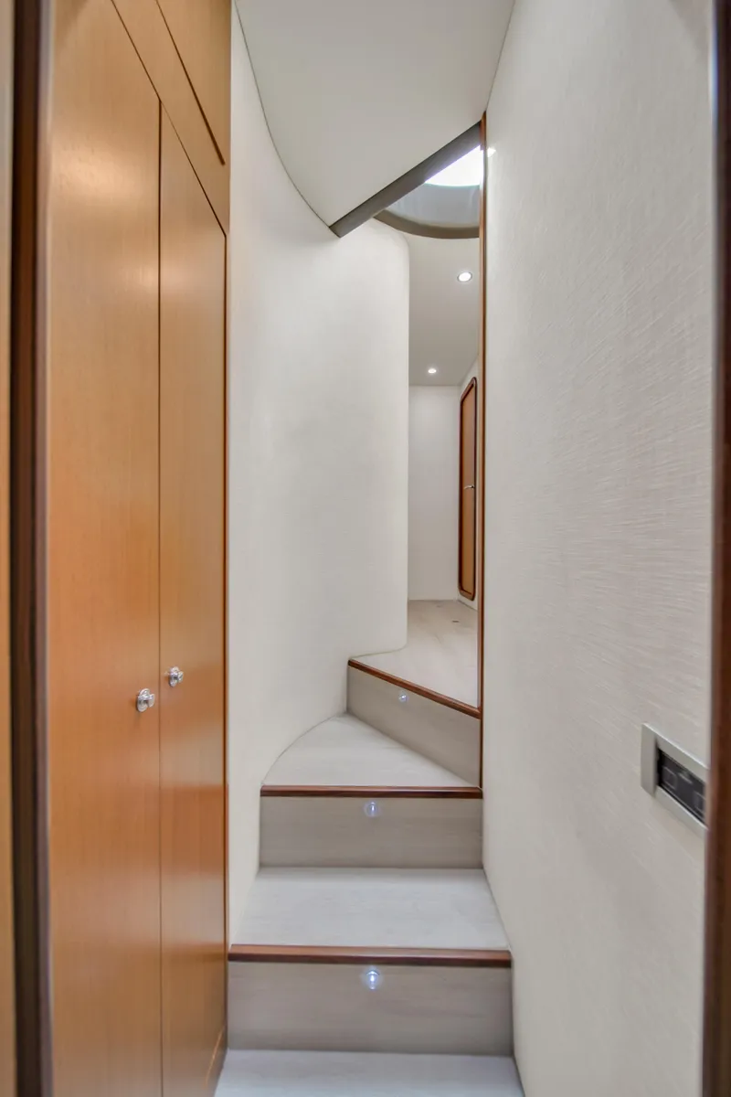 Slide: The Image of Interior staircase of 2011 Ferretti Yachts 660, featuring sleek wooden design. - 45