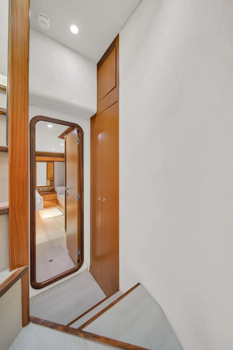 Slide: The Image of Interior hallway of 2011 Ferretti Yachts 660, featuring wooden finishes and modern design. - 46