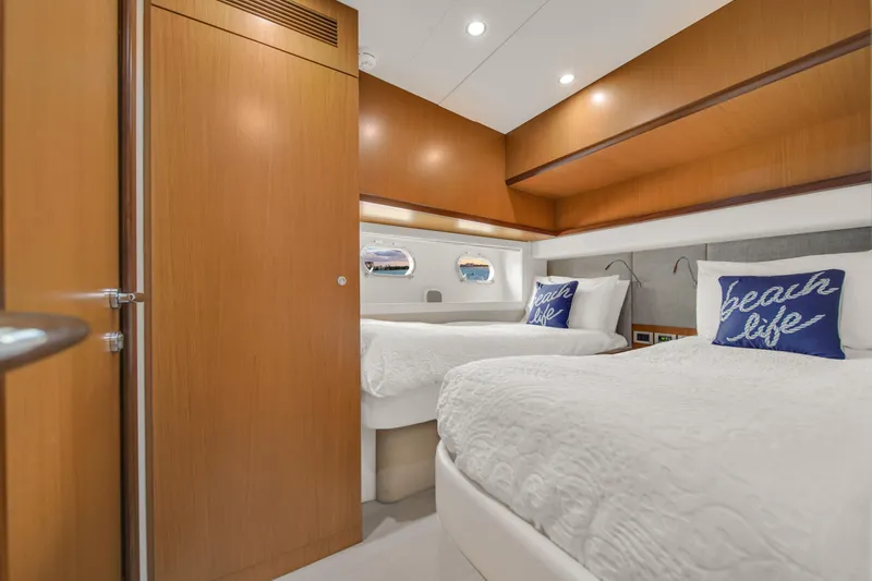 Slide: The Image of Luxurious cabin interior of 2011 Ferretti Yachts 660 with twin beds and nautical decor. - 49
