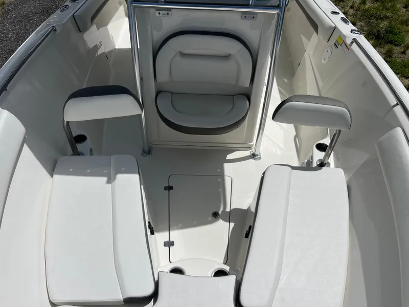 Slide: The Image of 2021 Sailfish 242 CC boat interior with cushioned seating and storage compartments. - 11