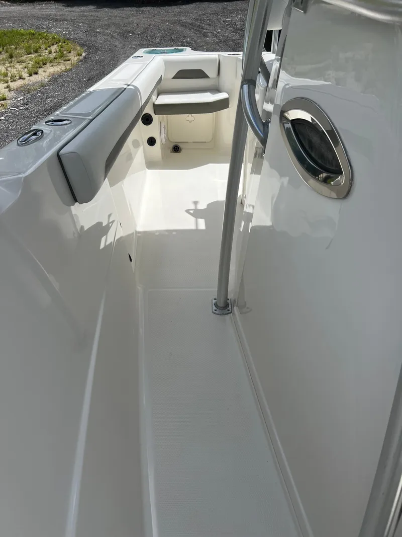 Slide: The Image of 2021 Sailfish 242 CC boat interior, featuring sleek white seating and modern design. - 13