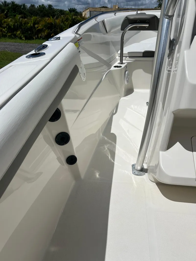 Slide: The Image of 2021 Sailfish 242 CC boat interior with sleek white design and modern features. - 17