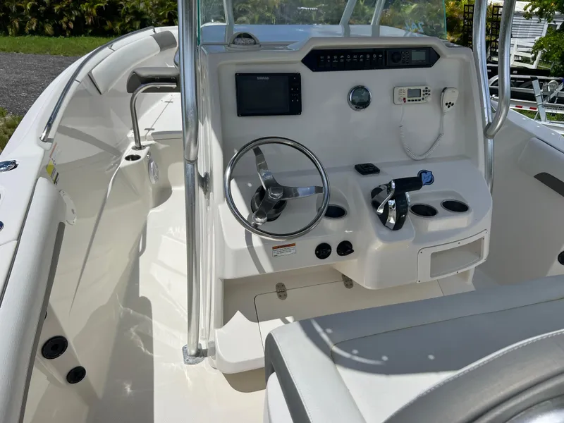 Slide: The Image of 2021 Sailfish 242 CC boat cockpit with steering wheel and control panel. - 20