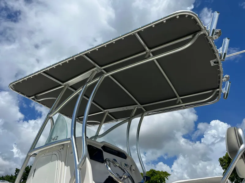 Slide: The Image of Sailfish 242 CC 2021 boat with T-top against a cloudy sky. - 21