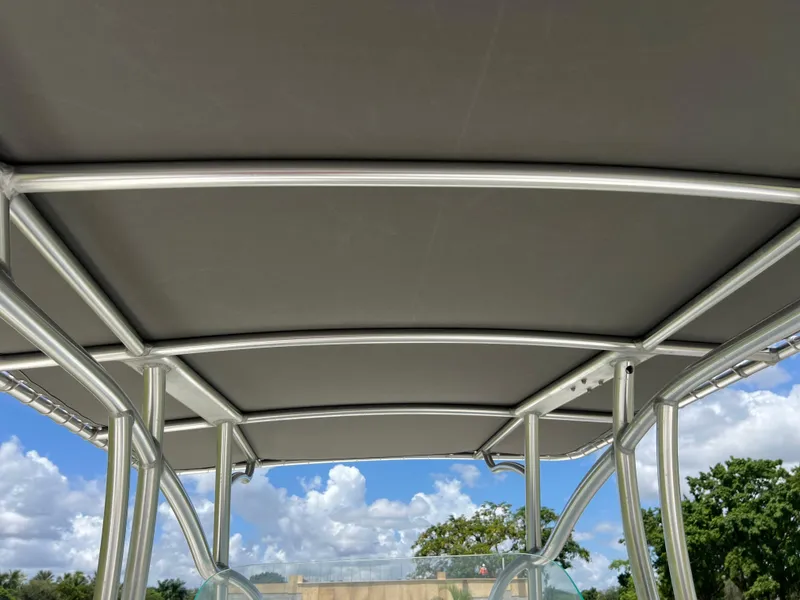 Slide: The Image of Sailfish 242 CC 2021 boat canopy with metal frame under blue sky. - 22