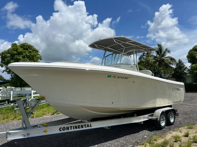Slide: The Image of 2021 Sailfish 242 CC boat on trailer under blue sky. - 3