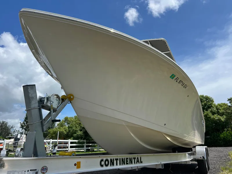 Slide: The Image of 2021 Sailfish 242 CC boat on Continental trailer under blue sky. - 5