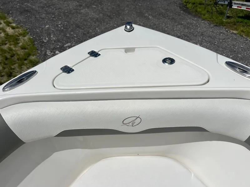 Slide: The Image of 2021 Sailfish 242 CC boat bow with storage compartment and sleek design. - 9