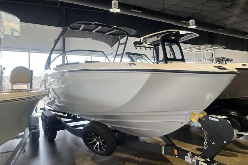 The Image of 2025 Yamaha Boats AR250 displayed in showroom, sleek design on trailer. - 0