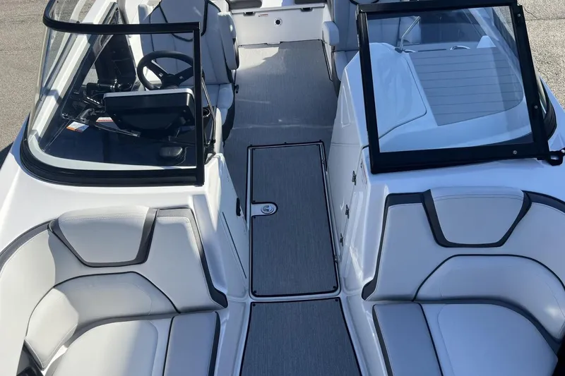 Slide: The Image of 2025 Yamaha Boats AR250 interior with sleek seating and modern dashboard design. - 23
