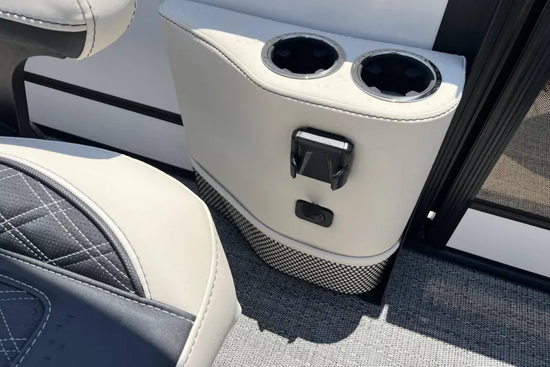 Slide: The Image of 2026 Barletta L25UCA boat interior with cup holders and seating detail. - 13