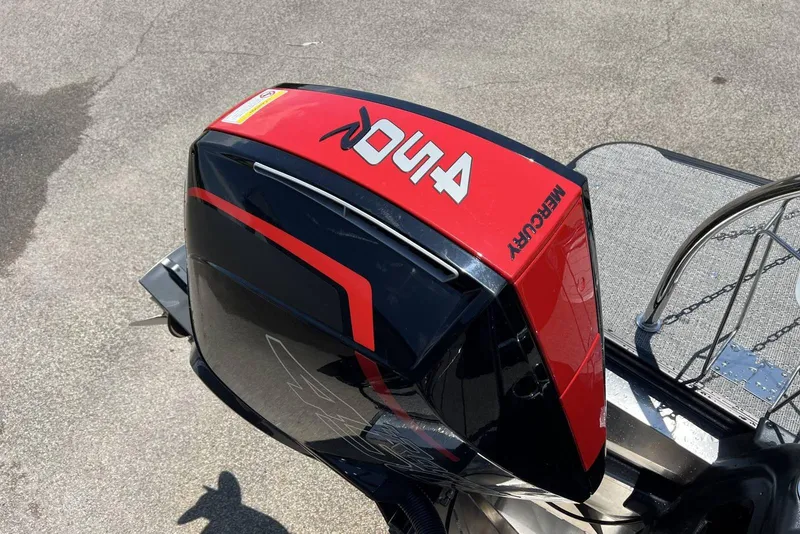 Slide: The Image of 2026 Barletta L25UCA boat with a Mercury outboard motor, red and black design. - 7