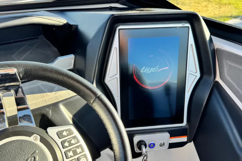 Slide: The Image of 2021 Tigé Z3 boat dashboard with touchscreen display and steering wheel controls. - 18