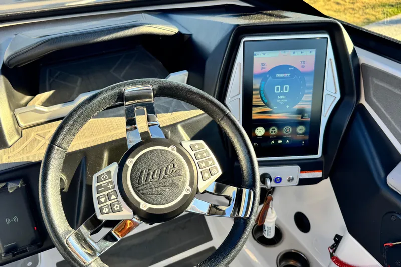 Slide: The Image of Steering wheel and touchscreen display of 2021 Tigé Z3 boat dashboard. - 19