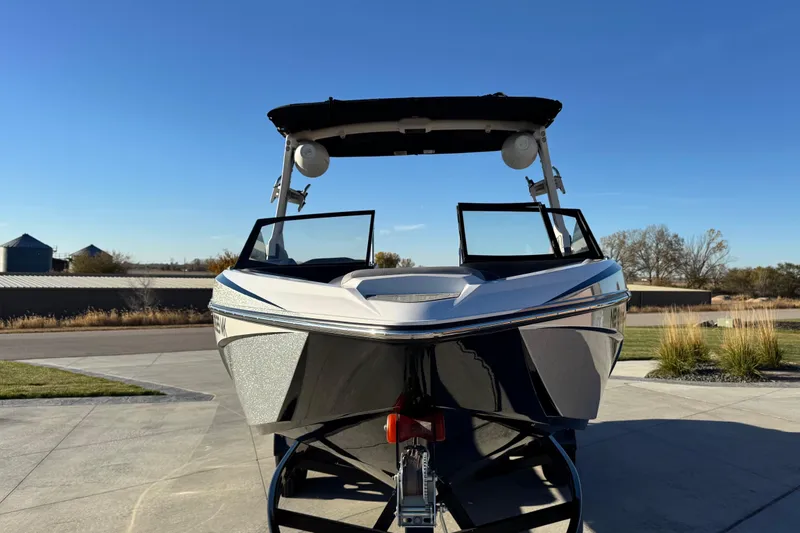 Slide: The Image of 2021 Tigé Z3 boat on trailer, parked outdoors under clear blue sky. - 2