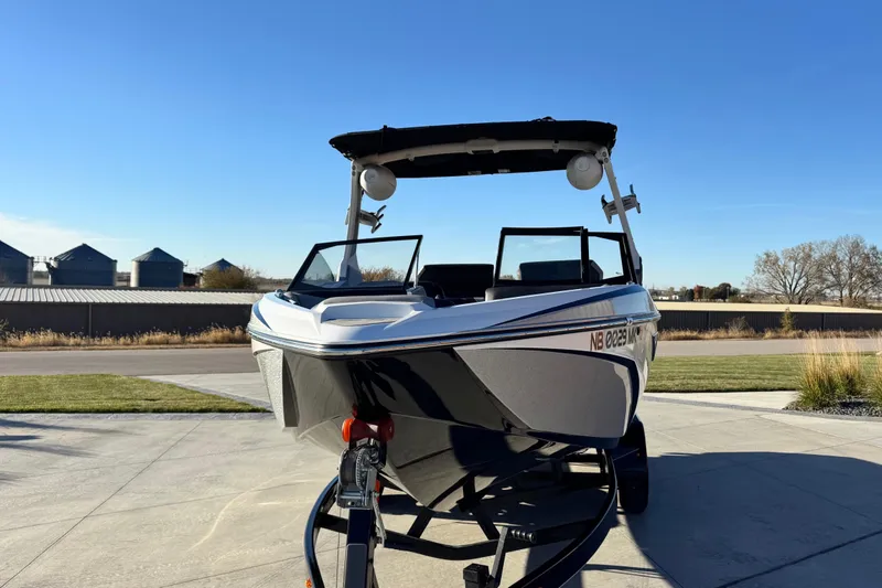 Slide: The Image of 2021 Tigé Z3 boat on trailer, parked outdoors under clear blue sky. - 3