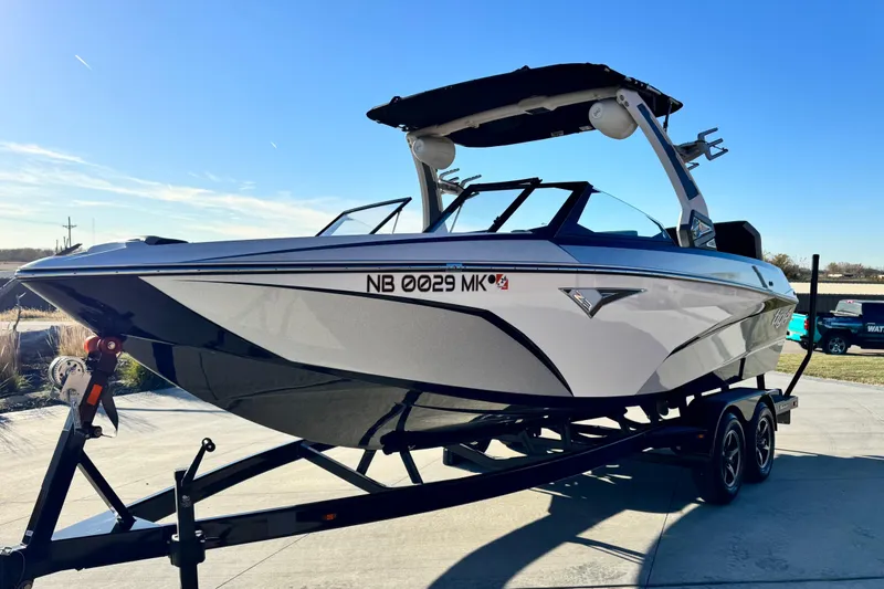 Slide: The Image of 2021 Tigé Z3 boat on trailer under clear blue sky. - 4