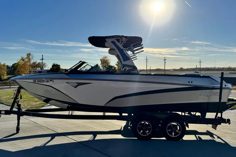 Slide: The Image of 2021 Tigé Z3 boat on trailer under clear sky, side view. - 6