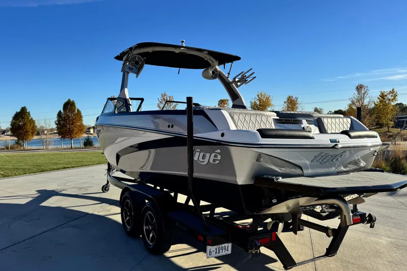 Slide: The Image of 2021 Tigé Z3 boat on trailer, parked outdoors under clear blue sky. - 7