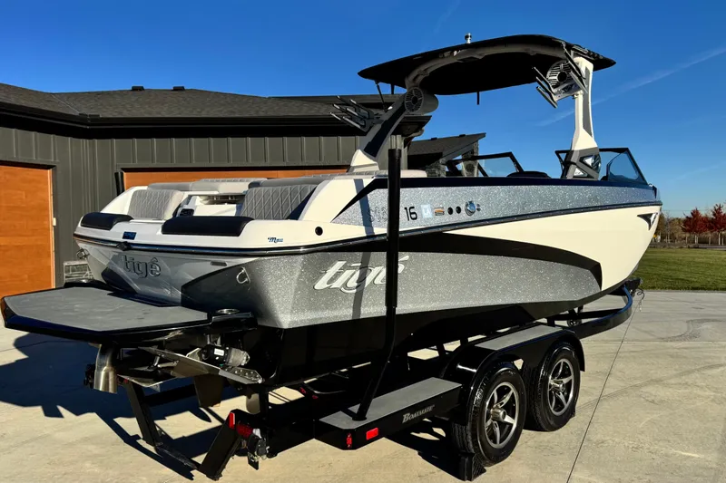 Slide: The Image of 2021 Tigé Z3 boat on trailer, parked outdoors under clear blue sky. - 9