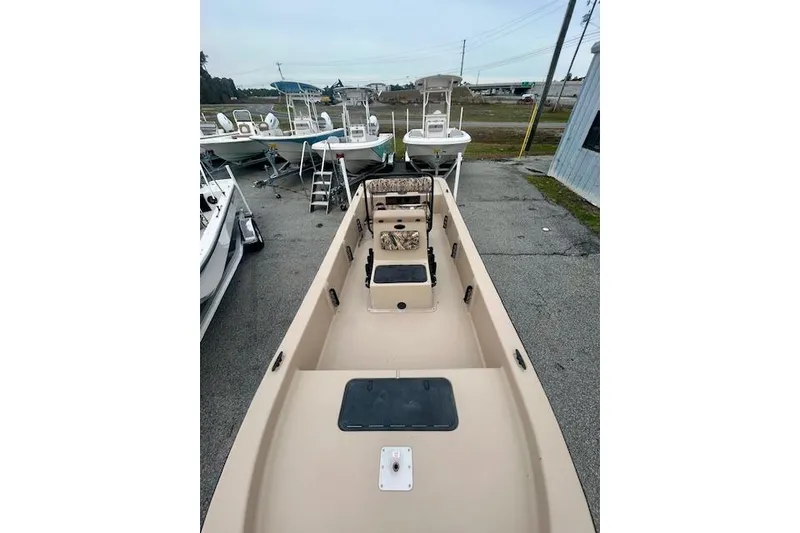 Slide: The Image of 2026 Carolina Skiff E20 JVX CC boat, beige interior, parked outdoors. - 3