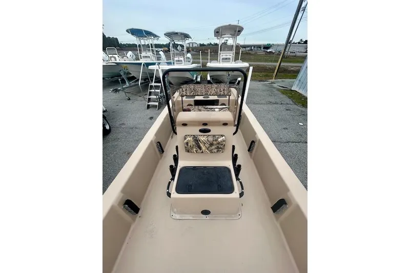 Slide: The Image of 2026 Carolina Skiff E20 JVX CC boat interior, featuring seating and storage compartments. - 4