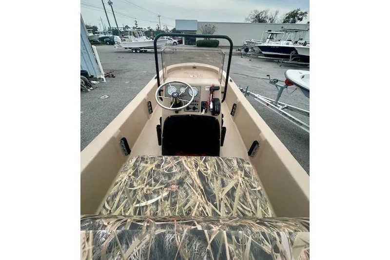 Slide: The Image of 2026 Carolina Skiff E20 JVX CC boat interior with camouflage seating and steering console. - 6