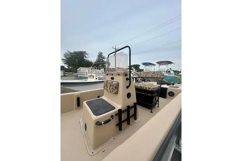 Slide: The Image of 2026 Carolina Skiff E20 JVX CC boat with beige interior and camouflage seating. - 7