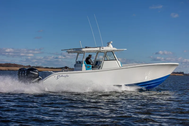 Slide: The Image of 2018 Yellowfin 39 Offshore boat cruising on open water under clear blue sky. - 22
