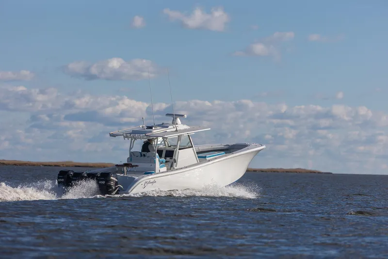 Slide: The Image of 2018 Yellowfin 39 Offshore boat cruising on open water under a clear sky. - 27
