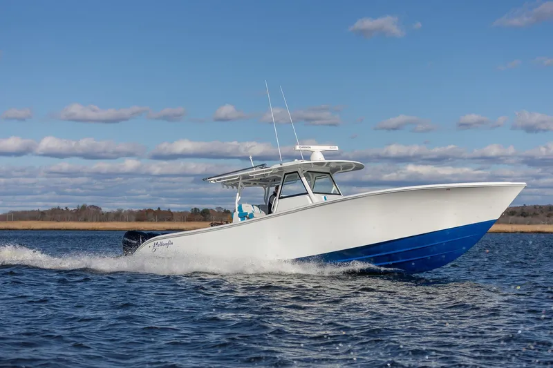 Slide: The Image of 2018 Yellowfin 39 Offshore boat cruising on open water under a clear blue sky. - 32