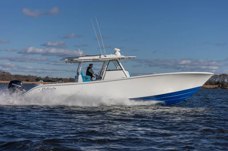 Slide: The Image of 2018 Yellowfin 39 Offshore boat cruising on open water under a clear blue sky. - 34