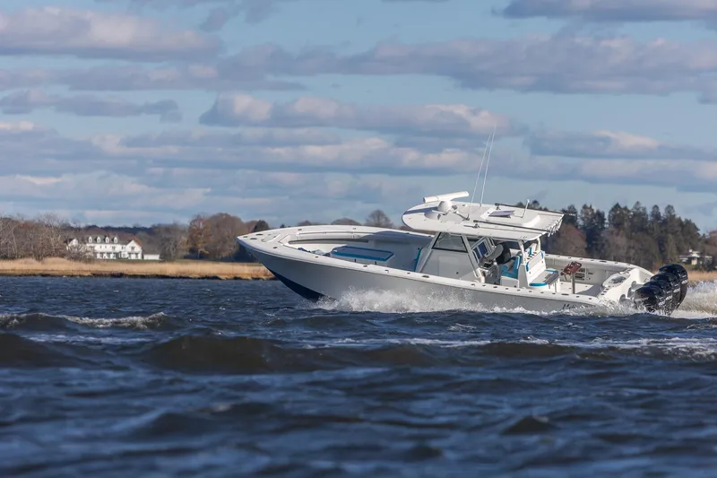 Slide: The Image of 2018 Yellowfin 39 Offshore boat cruising on a scenic waterway. - 36