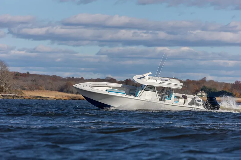 Slide: The Image of 2018 Yellowfin 39 Offshore boat cruising on a scenic waterway. - 37