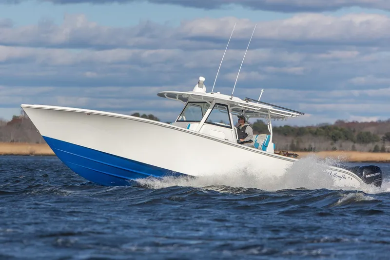 Slide: The Image of 2018 Yellowfin 39 Offshore boat cruising on open water under a cloudy sky. - 39