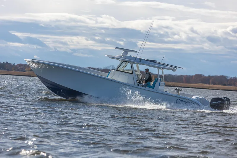 Slide: The Image of 2018 Yellowfin 39 Offshore boat cruising on open water under cloudy skies. - 52